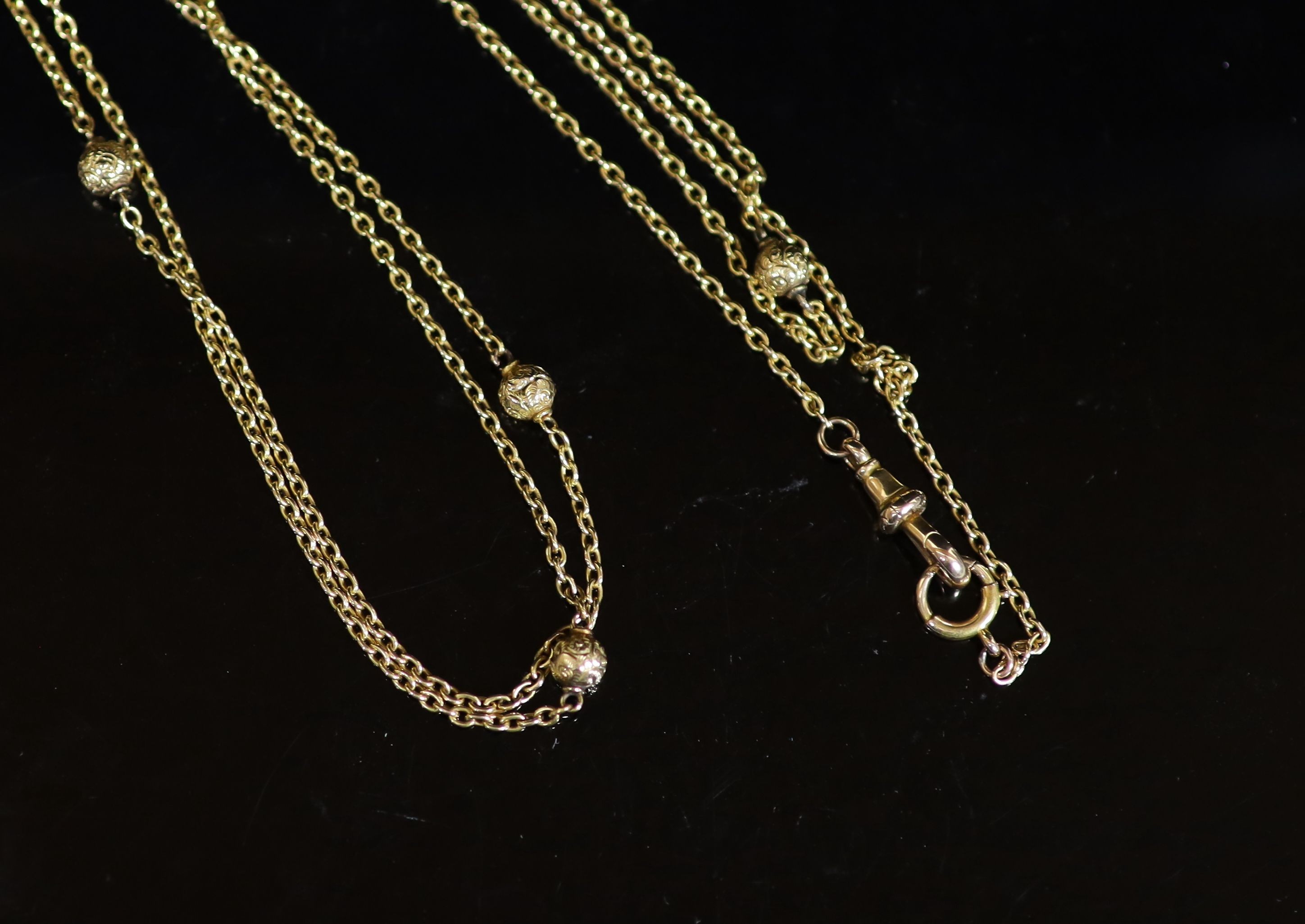 An early 20th century 15ct gold chain link and engraved bead guard chain, 135cm